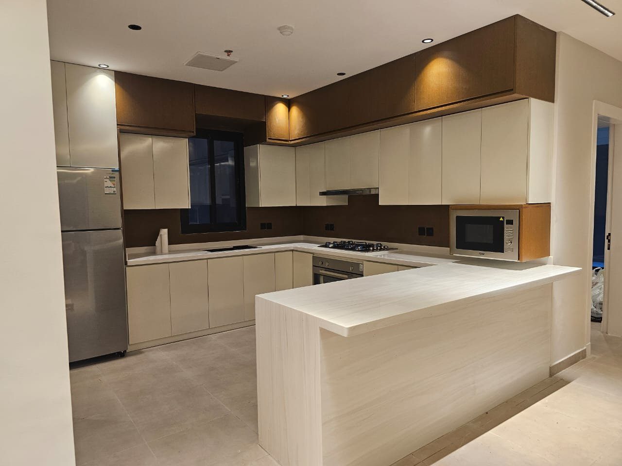 مطبخ كريمي مع طاولة إفطار